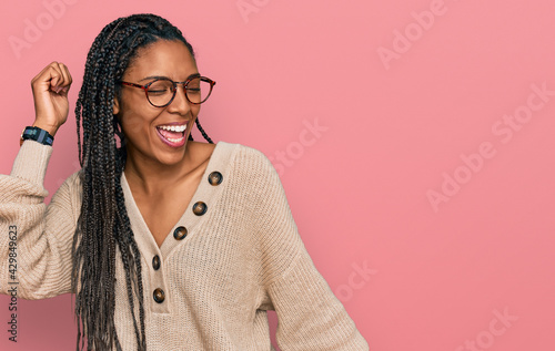 African american woman wearing casual clothes dancing happy and cheerful, smiling moving casual and confident listening to music
