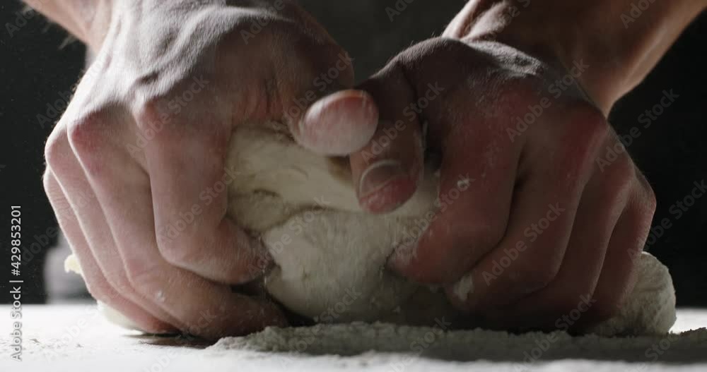 Hands of professional baker kneading dough. Chef carefully making bread with traditional recipe food and drink close up 4k footage