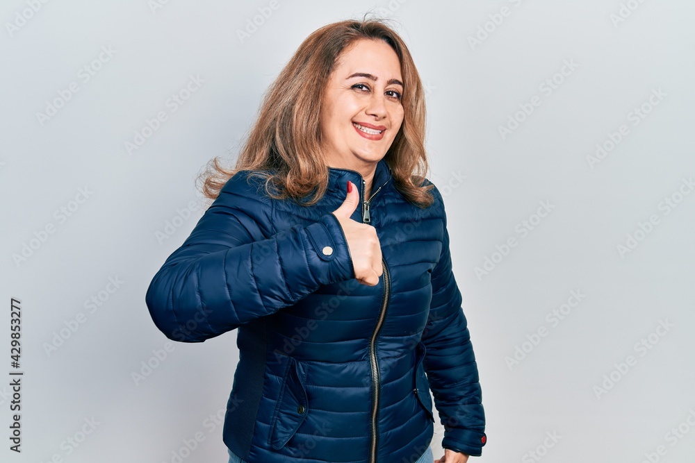 Middle age caucasian woman wearing casual clothes doing happy thumbs up gesture with hand. approving expression looking at the camera showing success. Middle age caucasian woman wearing casual clothes doing happy thumbs up gesture with hand. approving expression looking at the camera showing success.