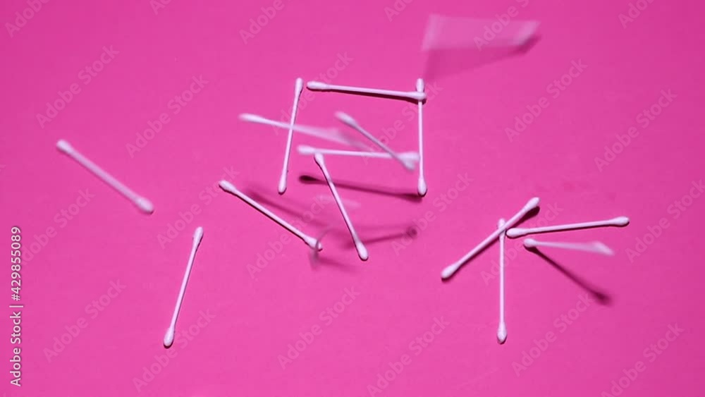 ear sticks on a pink cosmetics background