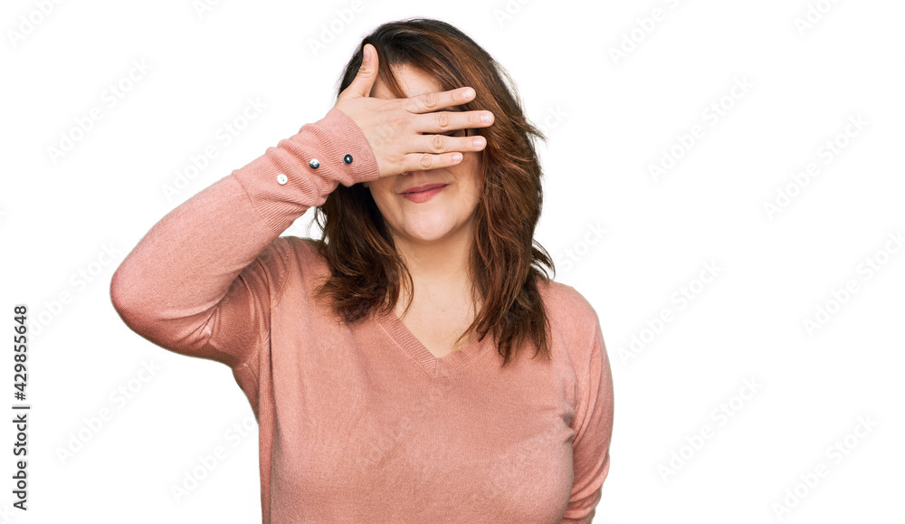 Young plus size woman wearing casual clothes and glasses covering eyes with hand, looking serious and sad. sightless, hiding and rejection concept Young plus size woman wearing casual clothes and glasses covering eyes with hand, looking serious and sad. sightless, hiding and rejection concept