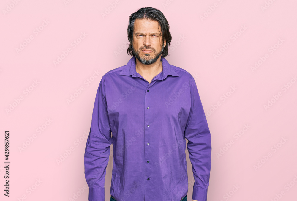 Middle age handsome man wearing business shirt skeptic and nervous, frowning upset because of problem. negative person. Middle age handsome man wearing business shirt skeptic and nervous, frowning upset because of problem. negative person.