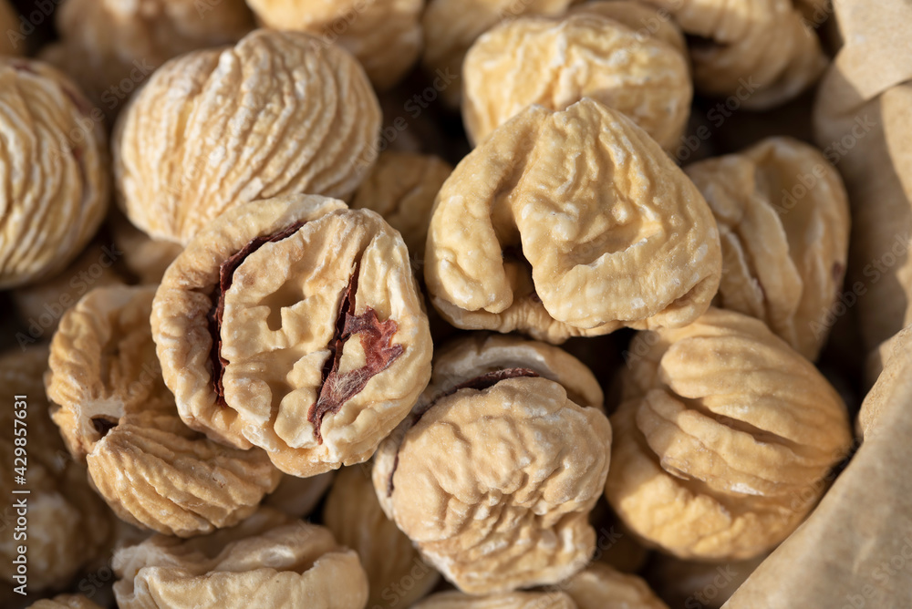 Close up and texture of dried chestnuts that are in a paper bag Close up and texture of dried chestnuts that are in a paper bag