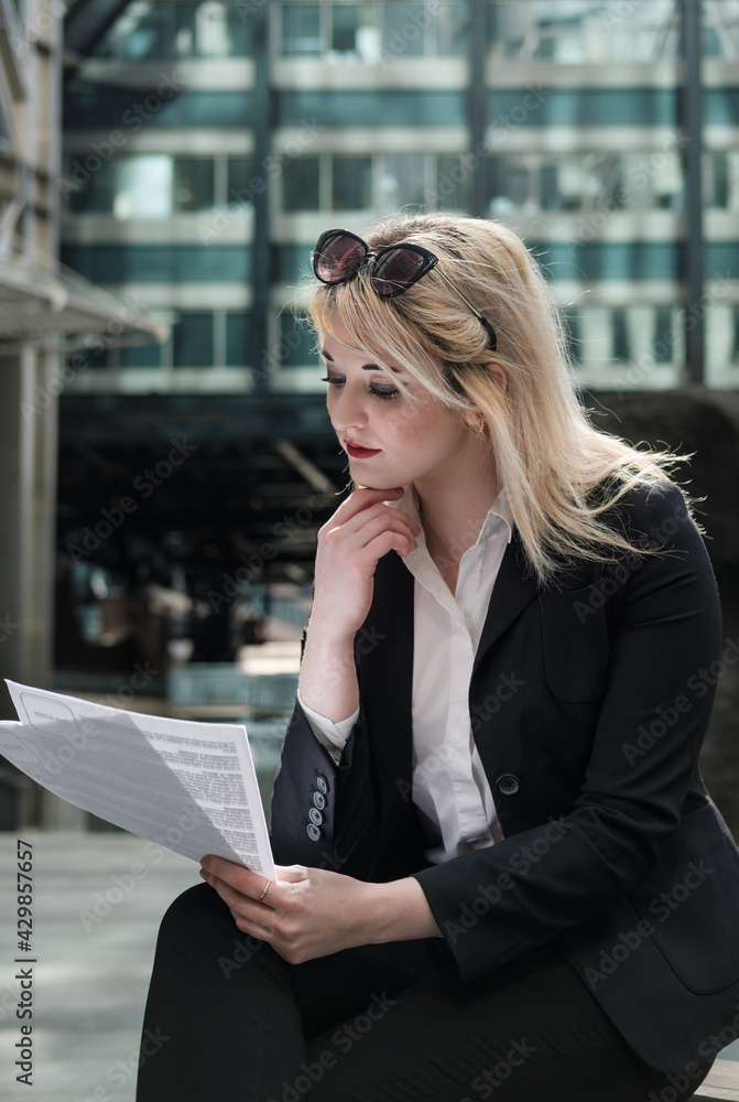businessswoman checking some papers outdoors.