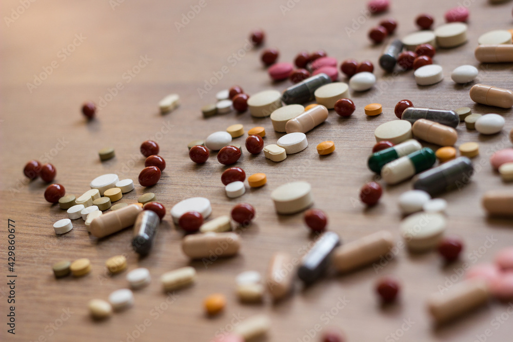 A photo of different medicinal drugs, tablets and pills on wooden background A photo of different medicinal drugs, tablets and pills on wooden background