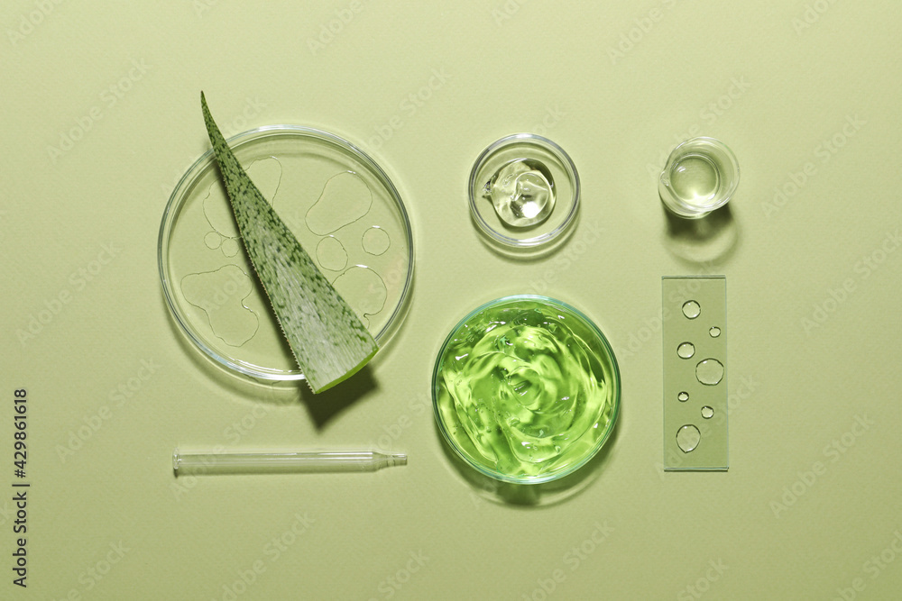 Organic cosmetic product, natural ingredients and laboratory glassware on green background, flat lay - obrazy, fototapety, plakaty 