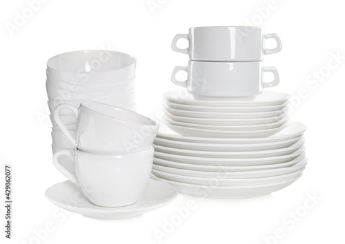 Stacked plates and cups on white background