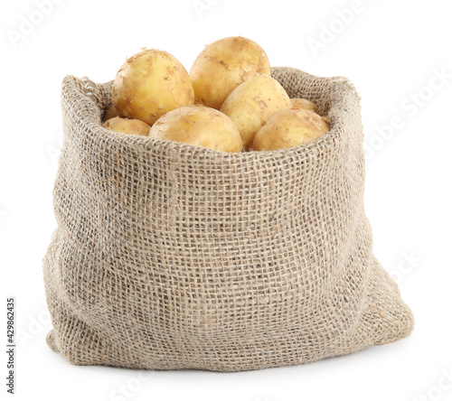 Raw fresh potatoes in sack bag isolated on white