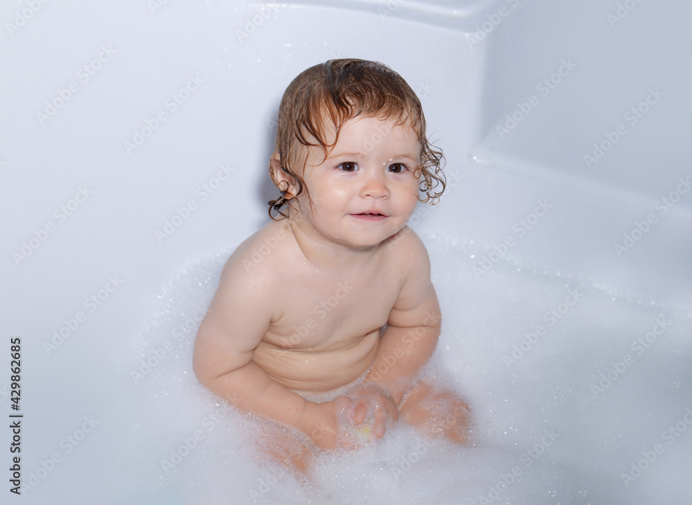 Todler in shower, funny infant in shower. Happy baby taking a bath playing with foam bubbles. Little child in a bathtub. Infant washing and bathing. Kids care and hygiene. Todler in shower, funny infant in shower. Happy baby taking a bath playing with foam bubbles. Little child in a bathtub. Infant washing and bathing. Kids care and hygiene.