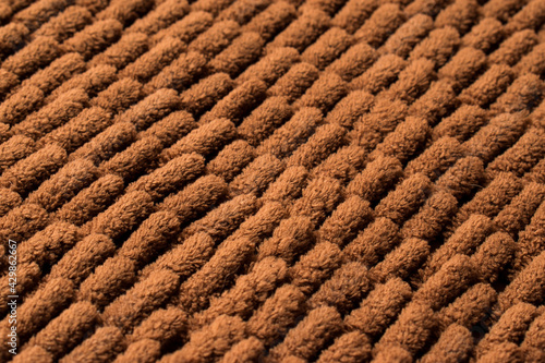 Close up of brown and soft rug texture with line pattern 