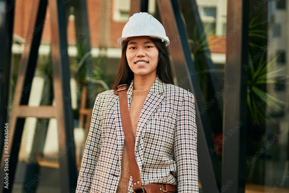 Young asian architect woman smiling happy standing at the city. Young asian architect woman smiling happy standing at the city.