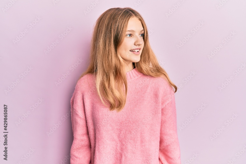 Beautiful young caucasian girl wearing casual clothes looking away to side with smile on face, natural expression. laughing confident. Beautiful young caucasian girl wearing casual clothes looking away to side with smile on face, natural expression. laughing confident.