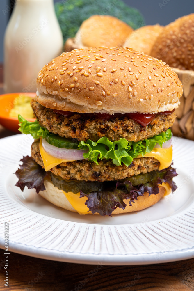 Tasty vegetarian cheeseburgers with round patties or burgers made from grains, vegetables and legumes Tasty vegetarian cheeseburgers with round patties or burgers made from grains, vegetables and legumes