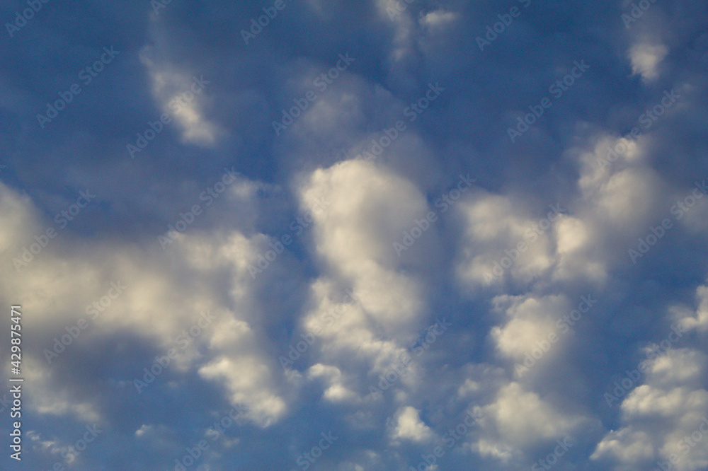Blue sky with white clouds and sun reflecting