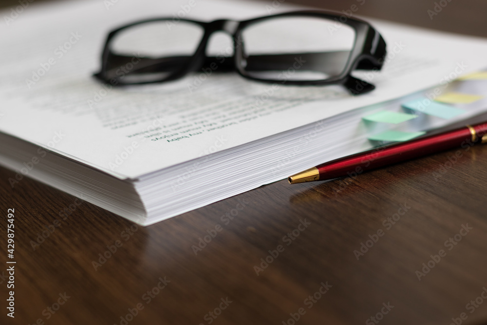 Paper folder with documents on the table, glasses, pen. Paper folder with documents on the table, glasses, pen.