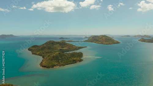 Aerial drone small island group in province of Palawan. Busuanga, Philippines. Seascape, islands covered with forest, sea with blue water. tropical landscape, travel concept