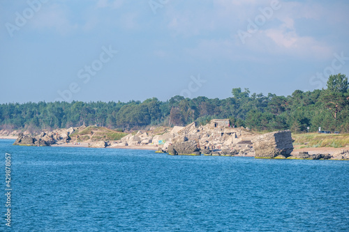 Fototapeta Naklejka Na Ścianę i Meble -  empty sandy beach by the sea with rocks