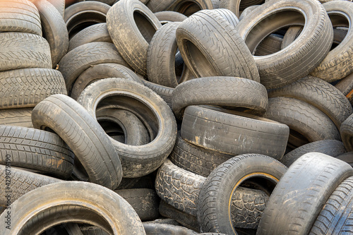Rubber tires in a landfill. Old wheels from cars. Recycling rubber. Garbage dump with damaged wheels. Environmental pollution. A lot of waste. Tires with protectors