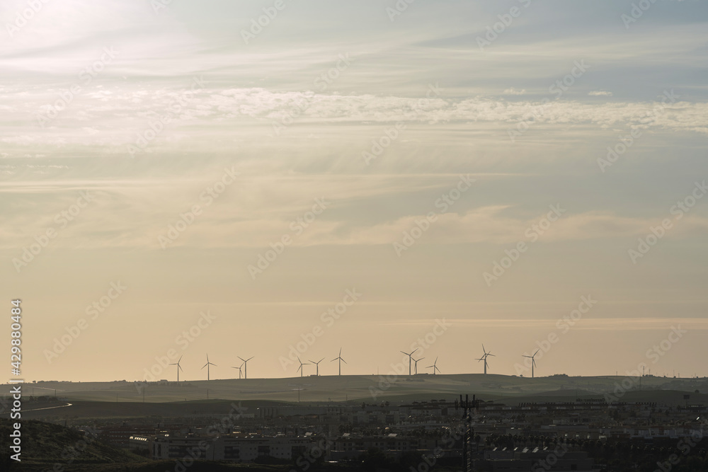 Beautiful view of a field with wind turbines in the distance

