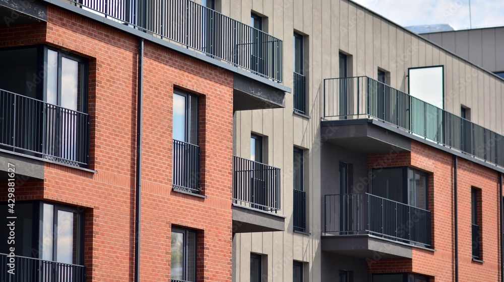 Architectural details of modern apartment building. Modern european residential apartment building complex with sunlight.