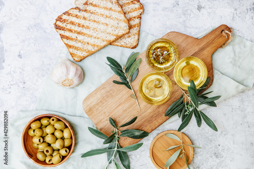 Wallpaper Mural Olive Oil. Organic olive oil in bowl with green olives, herbs, spices and ciabatta bread on white background , banner, healthy mediterranean food concept... Torontodigital.ca