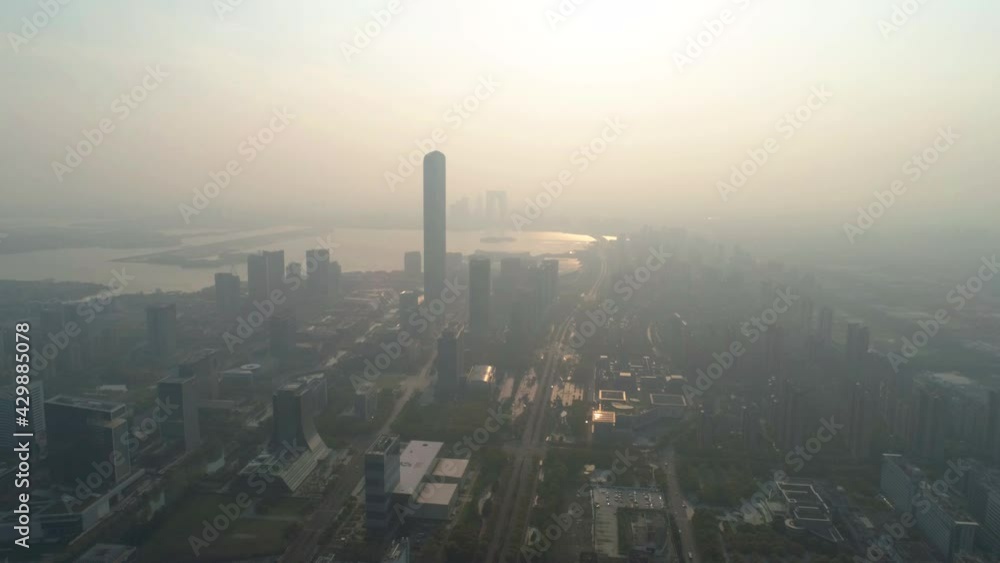Suzhou, China - April 4, 2020: Aerial view of skyscrapers in smog and fog. Air pollution and choking smog cloak the skyline of Suzhou at sunset. Suzhou, China - April 4, 2020: Aerial view of skyscrapers in smog and fog. Air pollution and choking smog cloak the skyline of Suzhou at sunset.