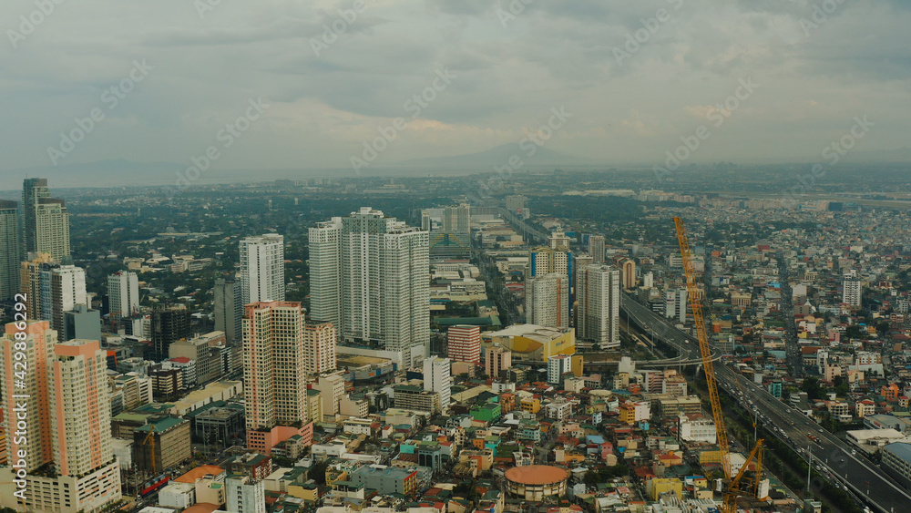 Manila city with skyscrapers, modern buildings and Makati business center, aerial drone. Travel vacation concept.