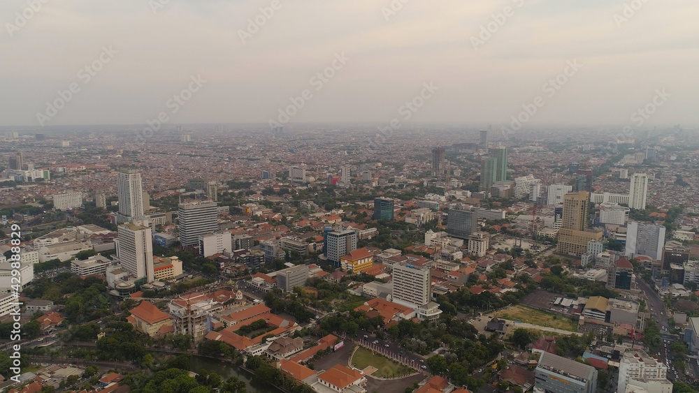 Aerial cityscape modern city Surabaya with skyscrapers, buildings and houses. sunset in city skyline with skyscrapers and business centers Surabaya capital city east java, indonesia