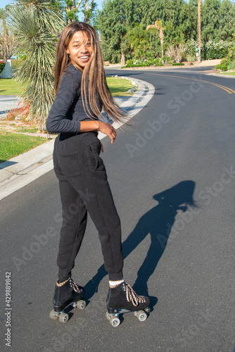 Young African-American women roller skates on street