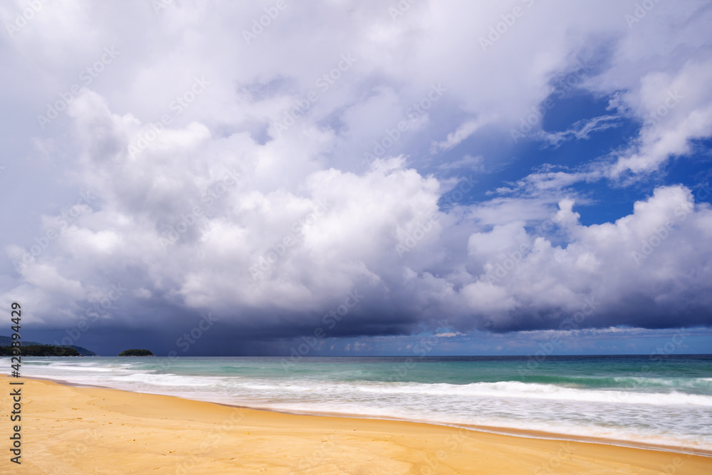 Dramatic dark storm white cloud over the sea with pouring rain in the distance over the Ocean along the shoreline,view looking from tranquil beach on phuket island.Environment, Climate change concepts