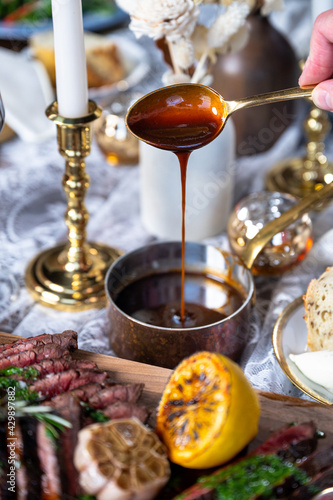 Sliced steak on a board with bordelaise sauce