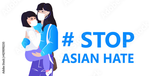 stop asian hate mother with child activists in masks protesting against racism support people during coronavirus