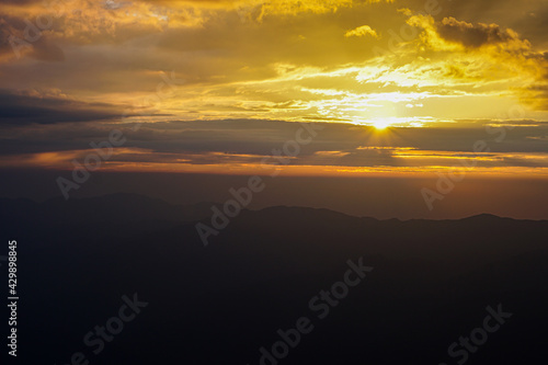 Mountain ridge on Huangshan mountain Nature landscape view of Beautiful  sunset sky above clouds with dramatic light Sunshine background landscape scene View of mountains and valley on silhouette sun.