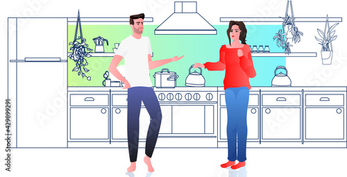 man woman discussing at kitchen couple spending time together at home full length
