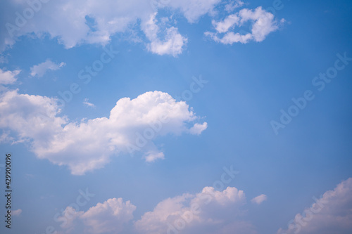 Jesus Christ in blue sky with clouds, bright light from heaven, resurrection concept, easter background