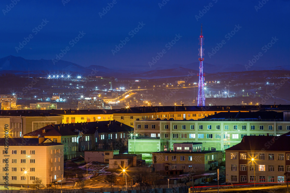 Night city landscape. Buildings and TV tower view. Magadan, Magadan Region, Siberia, Russia.