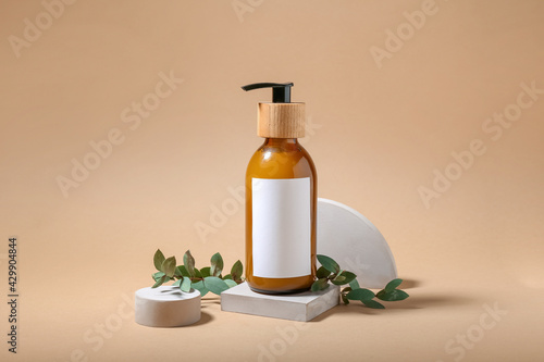 Composition with bottle of natural shampoo on color background photo