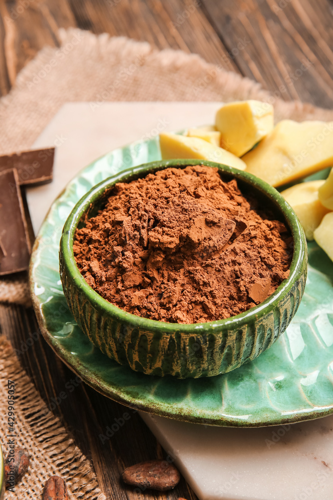 Bowl with cocoa powder on wooden background Bowl with cocoa powder on wooden background
