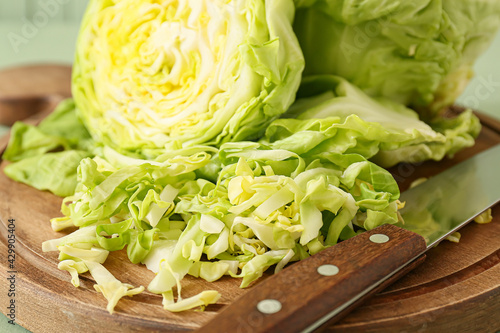 Fresh cut cabbages on wooden background