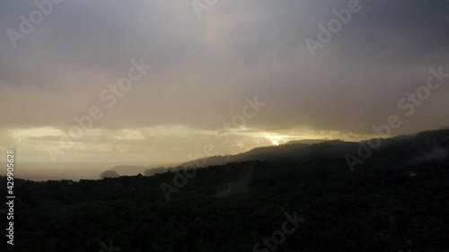 Sunset Aerial behind the mountains by the ocean in Jamaica