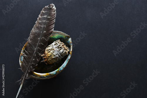 A top view image of a spiritual smudge kit on a black background.  photo