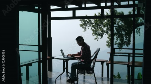 Wallpaper Mural Businessman working on laptop computer at home office. Male professional typing on laptop keyboard at office workplace. Working from home to reduce COVID-19 infection Torontodigital.ca