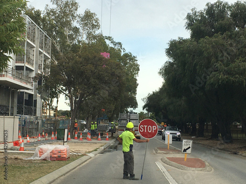 Builder holding a stop sign outside building site