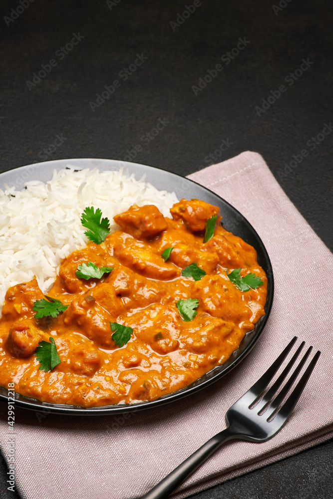 Plate of Traditional Chicken Curry and rice on dark concrete background Plate of Traditional Chicken Curry and rice on dark concrete background