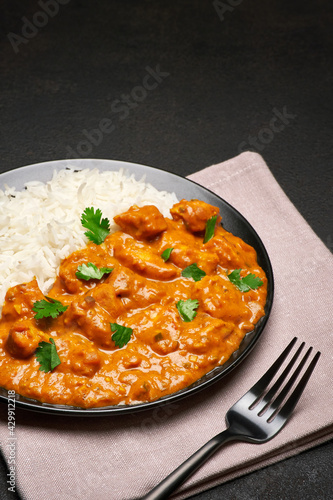 Plate of Traditional Chicken Curry and rice on dark concrete background