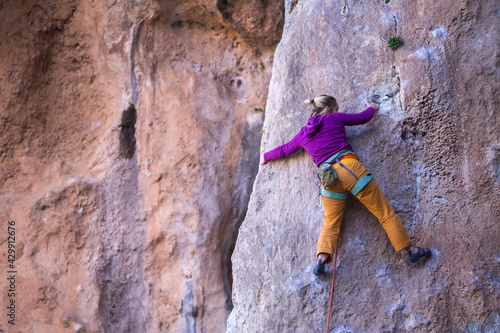 A girl trains strength and endurance on rocks