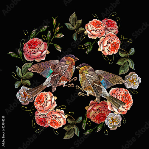 Embroidery ring from pink roses flowers and birds. Spring art. Classical embroidery n black background.  Fashionable template for clothes, t-shirt design