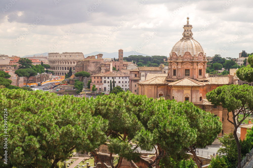 Panoramic view of Colosseum, via Fori Imperiali and Santi Luca e Martina church, Rome, Italy