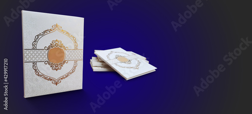 Indian wedding invitation cards mockup with shining reflective golden embroidery on white textured card isolated