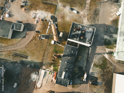 Old factory / manufacture from above. Chimney with smoke and polluted environment. 